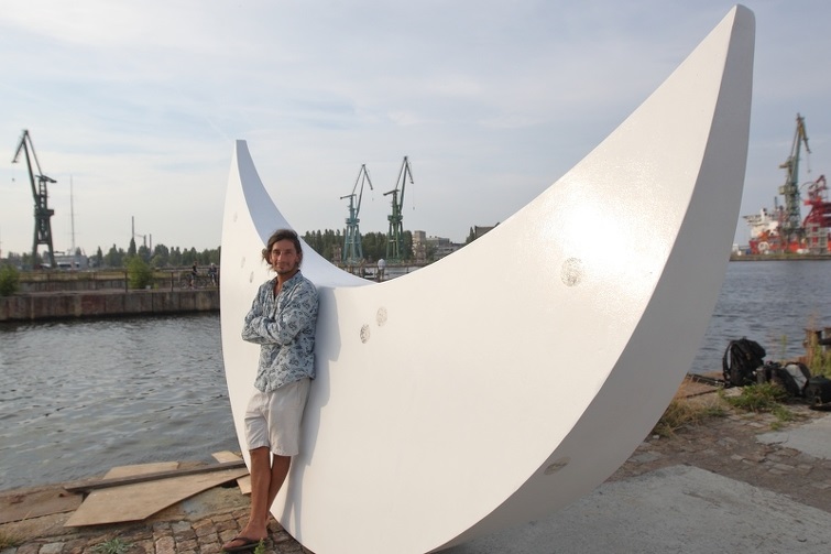 Bartolomeo Koczenasz standing in front of the sculpture Moon – A Gift from the People of Kraków to Pomerania, 2018