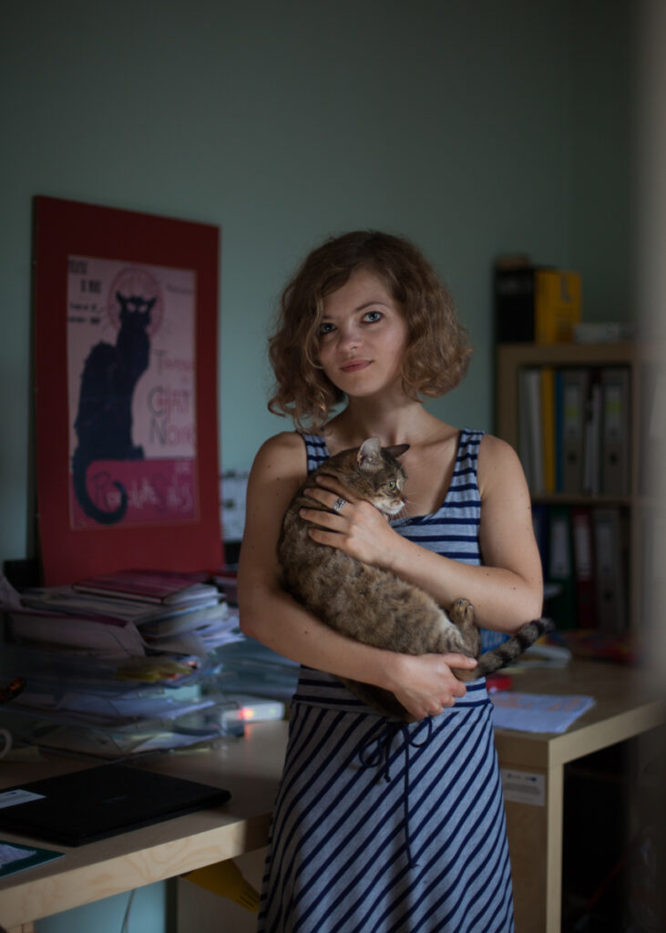 Portrait from the “21 Jewish Krakowians” series documenting contemporary Jewish life in Krakow. Paulina Skotnicka in her workplace posing with cat.