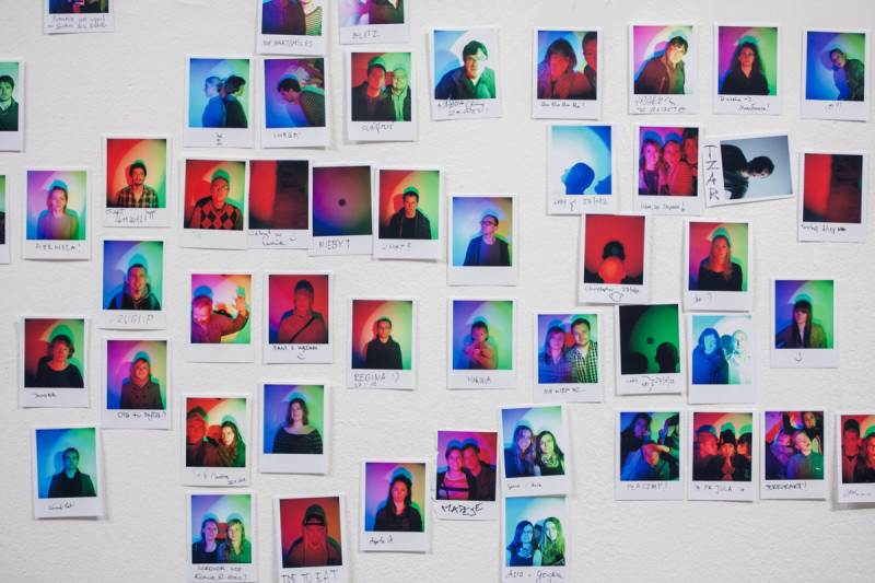 Gallery wall covered with hundreds of RGB self-portraits created by visitors using interactive photo booth.