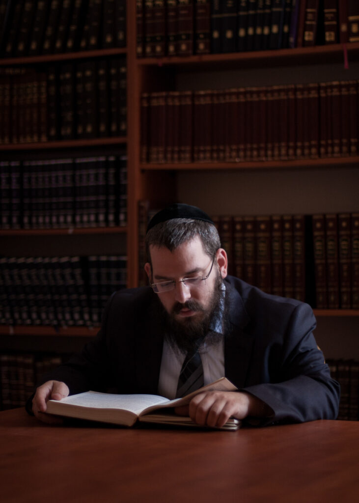 Portrait from the “21 Jewish Krakowians” series documenting contemporary Jewish life in Krakow. Rabbi Eliezer Gurary reading a tora.